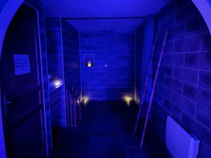 a dark hallway with blue lights in a room at Evad&vous in Recquignies