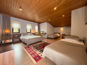 a large bedroom with two beds and a room with two beds at The Stone Sky Hotel in Gjirokastër +107 photos