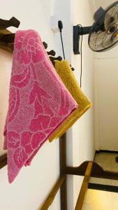 a group of towels hanging on a wall at Kanchi's please in Udawalawe