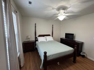 a bedroom with a bed and a ceiling fan at Magnolia place in Cleveland