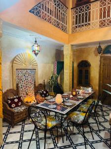 a dining room with a table and chairs at Casa Indigo in Rabat