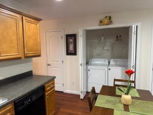 a kitchen with a dishwasher and a washer and dryer at Magnolia place in Cleveland