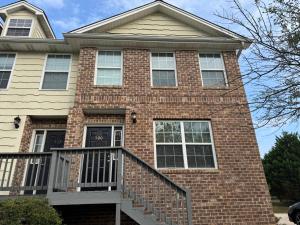 a brick house with a black front door at Magnolia place in Cleveland