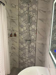 a bathroom with a shower and a white tub at Casa Indigo in Rabat