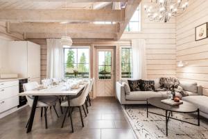a kitchen and dining room with a table and chairs at Villa Bear Den in Kittilä