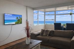 a living room with a couch and a view of the ocean at 32 Warnadoone- On Warner beach-Amanzimtoti in Kingsborough