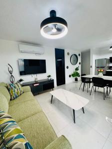 a living room with a couch and a table at Brand New Luxe Apartment 1 in Carolina