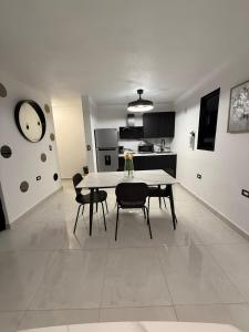 a kitchen and dining room with a table and chairs at Brand New Luxe Apartment 1 in Carolina +27 photos