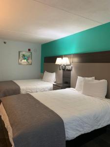 a hotel room with two beds and a blue wall at Sky Suites in Tybee Island +18 photos
