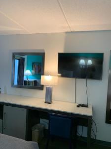 a room with a desk with a lamp and a mirror at Sky Suites in Tybee Island