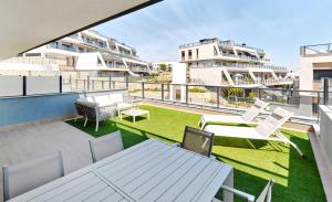 an apartment balcony with a table and chairs at Playa Carabassi Sea View Apartment in Gran Alacant, Large Terrace in Gran Alacant