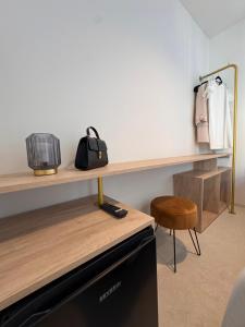 a room with a counter with a shelf and a chair at Hugo Beach Hotel & Apartments in Gandía