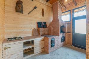 a kitchen with a stove and a brick oven at Forever young Bran in Sohodol