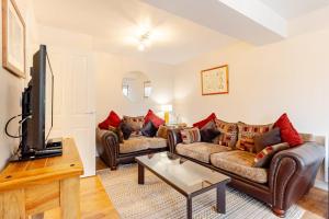 a living room with two couches and a tv at Acorns in Holywell