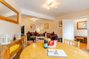 a living room with a table and a couch at Acorns in Holywell