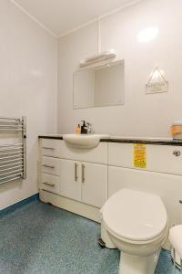 a bathroom with a white toilet and a sink at Acorns in Holywell +16 photos