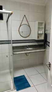 a bathroom with a mirror and a blue mat at Beach Garden Ap lagoa Serena in São Luís +24 photos