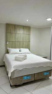 a bedroom with a large bed with a towel on it at Beach Garden Ap lagoa Serena in São Luís