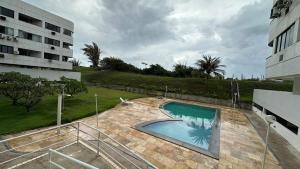 a swimming pool in front of a building at Beach Garden Ap lagoa Serena in São Luís