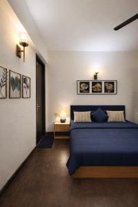 a bedroom with a blue bed in a room at Warm Embrace in Noida