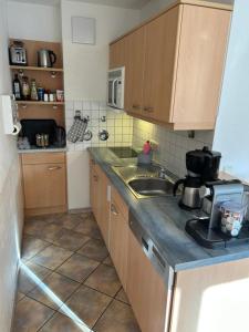 a kitchen with a sink and a counter top at Sunshine Lodge in Pfronten