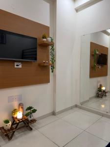 a living room with a flat screen tv on a wall at Luxe Label Studio by Sam in Zirakpur +33 photos