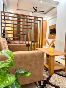 a living room with a couch and a table at Luxe Label Studio by Sam in Zirakpur