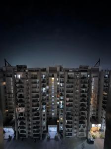 a tall apartment building at night at Luxe Label Studio by Sam in Zirakpur
