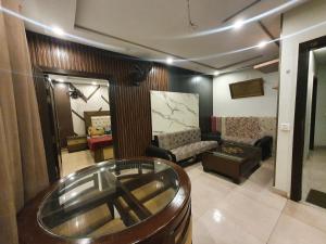 a living room with a couch and a table at Sunset heaven in Lahore