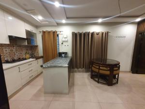 a kitchen with a counter and a table in it at Sunset heaven in Lahore