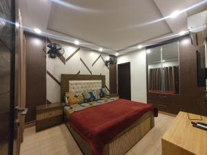 a bedroom with a large bed in a room at Sunset heaven in Lahore
