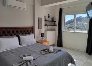 a bedroom with a large bed with a large window at Karel house in Karés