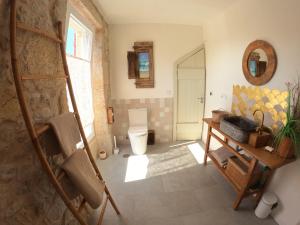 a bathroom with a toilet and a sink in a room at Hideaway Galicia Corrubedo in Corrubedo +17 photos