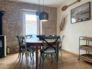 a dining room with a wooden table and chairs at Hideaway Galicia Corrubedo in Corrubedo