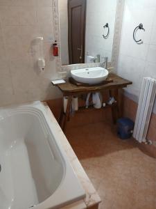 a bathroom with a bath tub and a sink at Casa Chiarli-Belforte Monferrato in Tagliolo Monferrato +30 photos