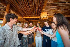 a group of people holding glasses of wine at Hostel 197 in Nungwi +58 photos