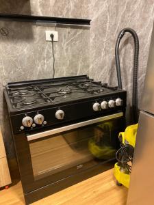 a black stove top oven in a kitchen at Clouds chase in Madinaty