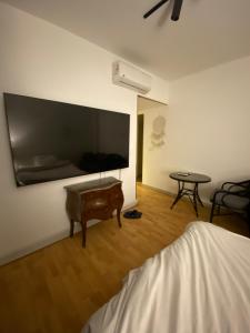 a room with a bed and a table and a tv at Clouds chase in Madinaty