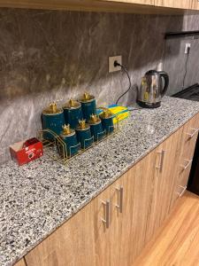 a counter with four blue drums on a counter top at Clouds chase in Madinaty +9 photos