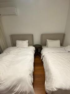 two beds sitting next to each other in a room at Clouds chase in Madinaty