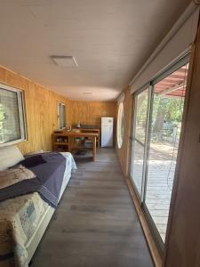 a bedroom with a bed and a table and a desk at Resolana y Rinconada in Isla del Rincón +21 photos
