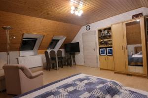 a room with a bed and a table and chairs at Fewo am Ith in Salzhemmendorf