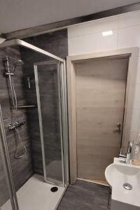 a bathroom with a shower and a toilet and a sink at Fewo am Ith in Salzhemmendorf +3 photos