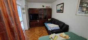 a living room with a couch and a table at Apartman Lea in Crikvenica