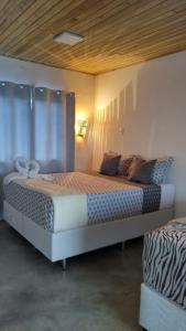 a bedroom with a large bed in a room at Pousada Cristal - Caraiva in Porto Seguro +18 photos