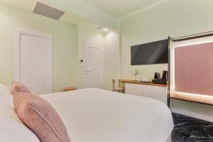 a hotel room with a bed and a flat screen tv at Nessun Dorma Suite in Manarola +20 photos