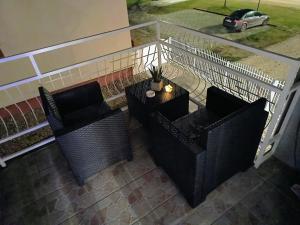 two chairs and a table on a balcony at Apartman Martinović in Županja