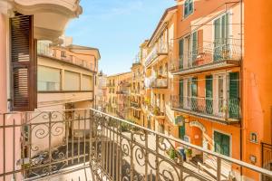 an apartment balcony in a city with buildings at Nessun Dorma Suite in Manarola