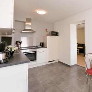 a kitchen with white cabinets and a counter top at Ferienhaus Herbert in Groß Kordshagen