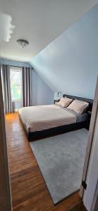 a bedroom with a bed and a large window at The Stirton House in Shelburne